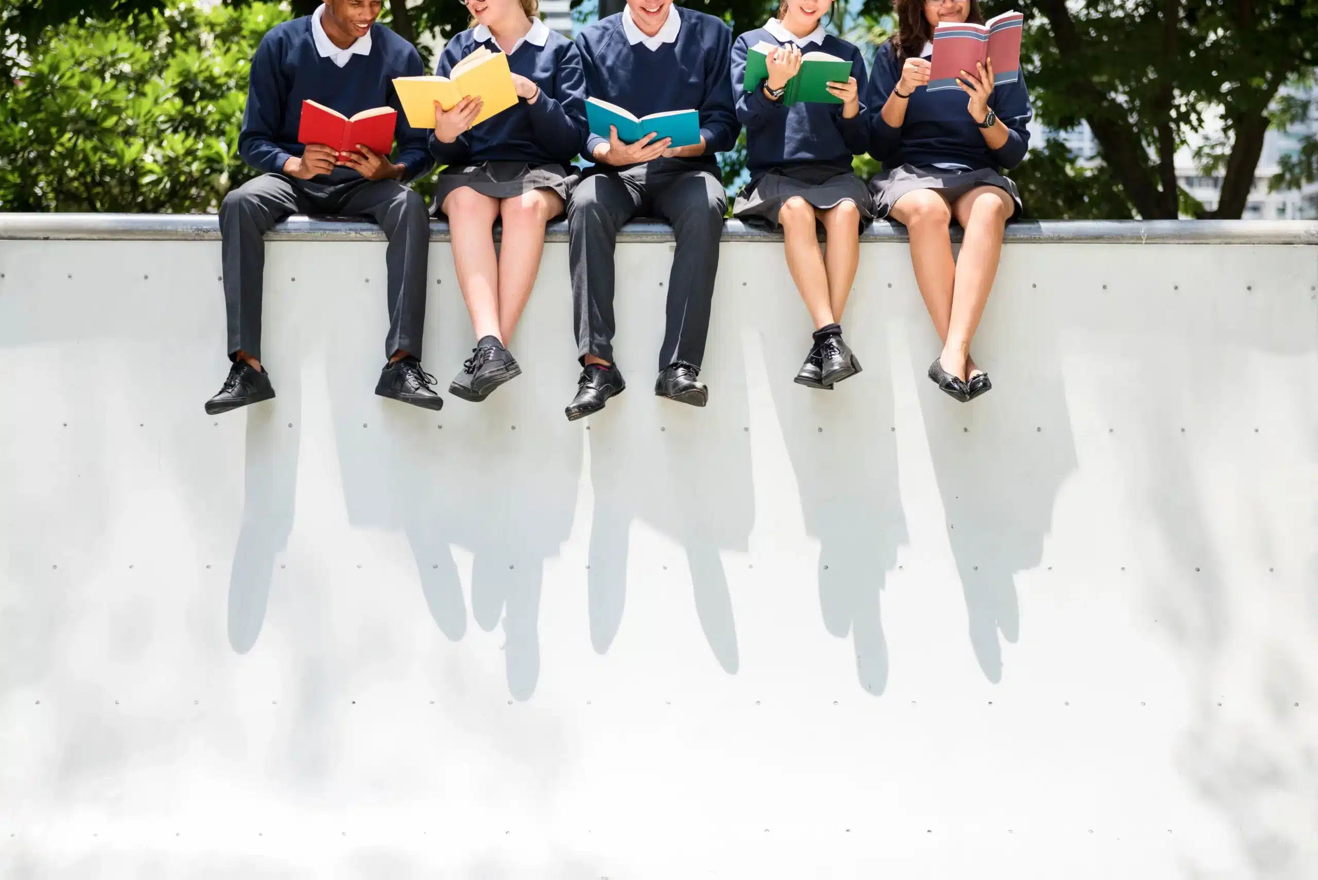 Students-sitting-on-a-ledge-outside_web-scaled
