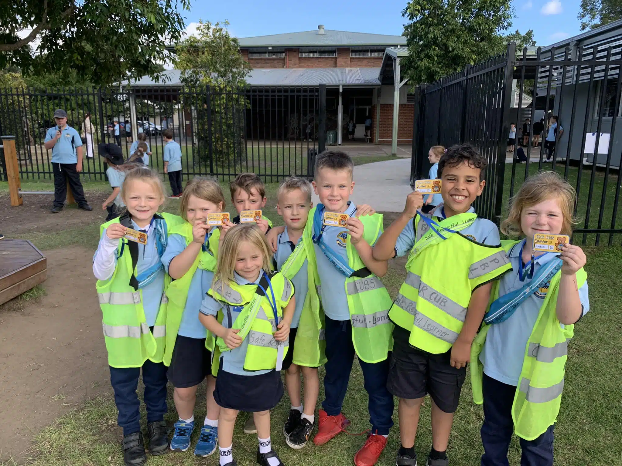 A group of children from Bomaderry Public School in safety vests posing for a photo.